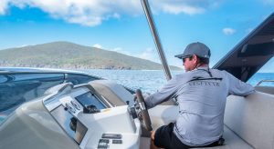Captain Robbie at the helm on C'Est La Vie, A 67' Lagoon powercat available for all inclusive crewed yacht charters