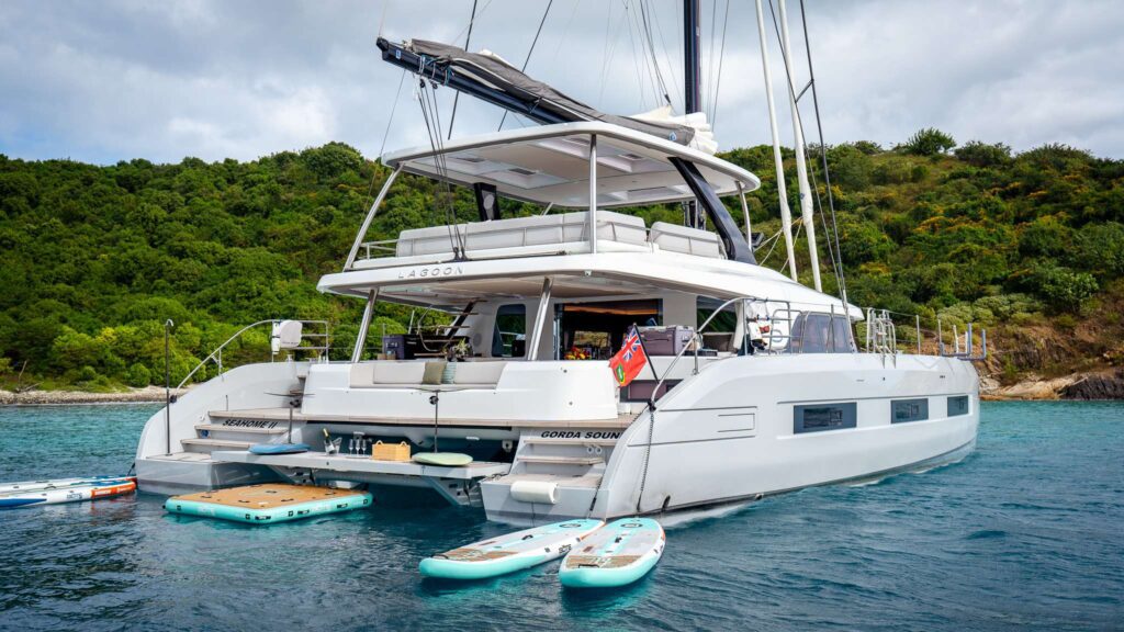 Seahome II, a 2025 10 passenger Lagoon 65 that offers tons of water toys and diving. At anchor in The BVI. Available for crewed yacht charter by Wlms Yacht Charters