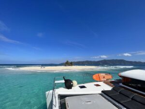 Jan's Felion, a Lagoon 630 powercat approaches deserted island in The BVI