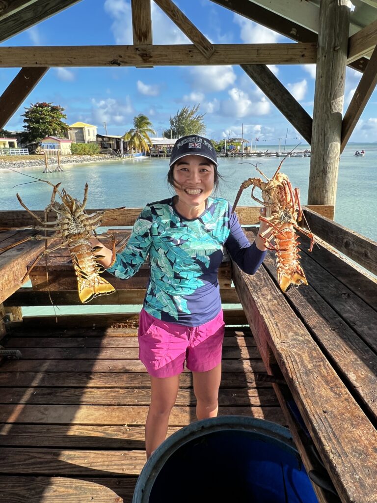 Mavis Lobsters in Anegada Mavis in Anegada holding lobsters