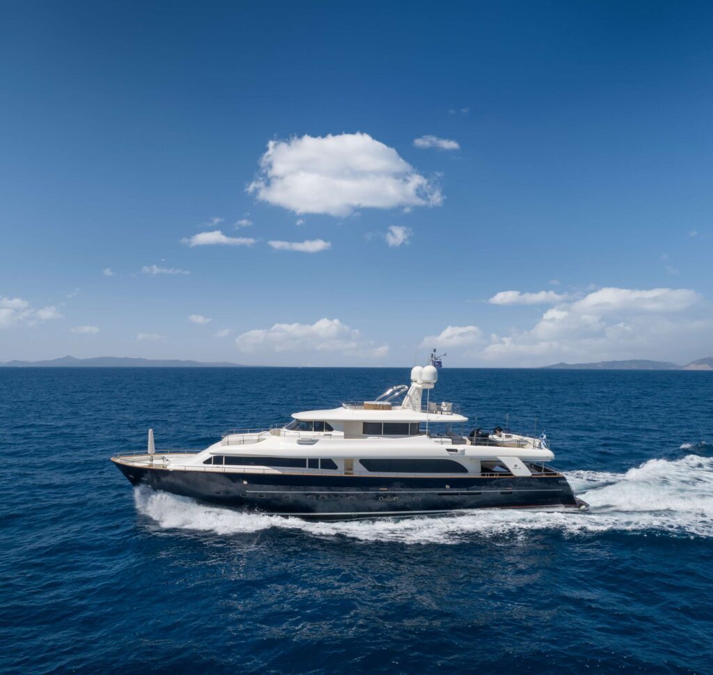 HAG, a 10 passenger 101' motor yacht underway as it cruises to Naxos, in The Cyclades. Available for private crewed yacht charter by Wlms Yacht Charters