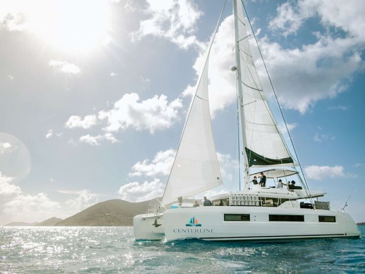 Wanderlust: A Lagoon 50 catamaran underway available for all inclusive crewed yacht charter in the BVI